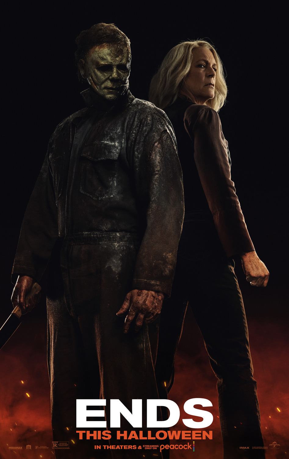 Michael Meyers and Laurie Strode stand back to back against a dark background with embers and smoke surrounding their feet.