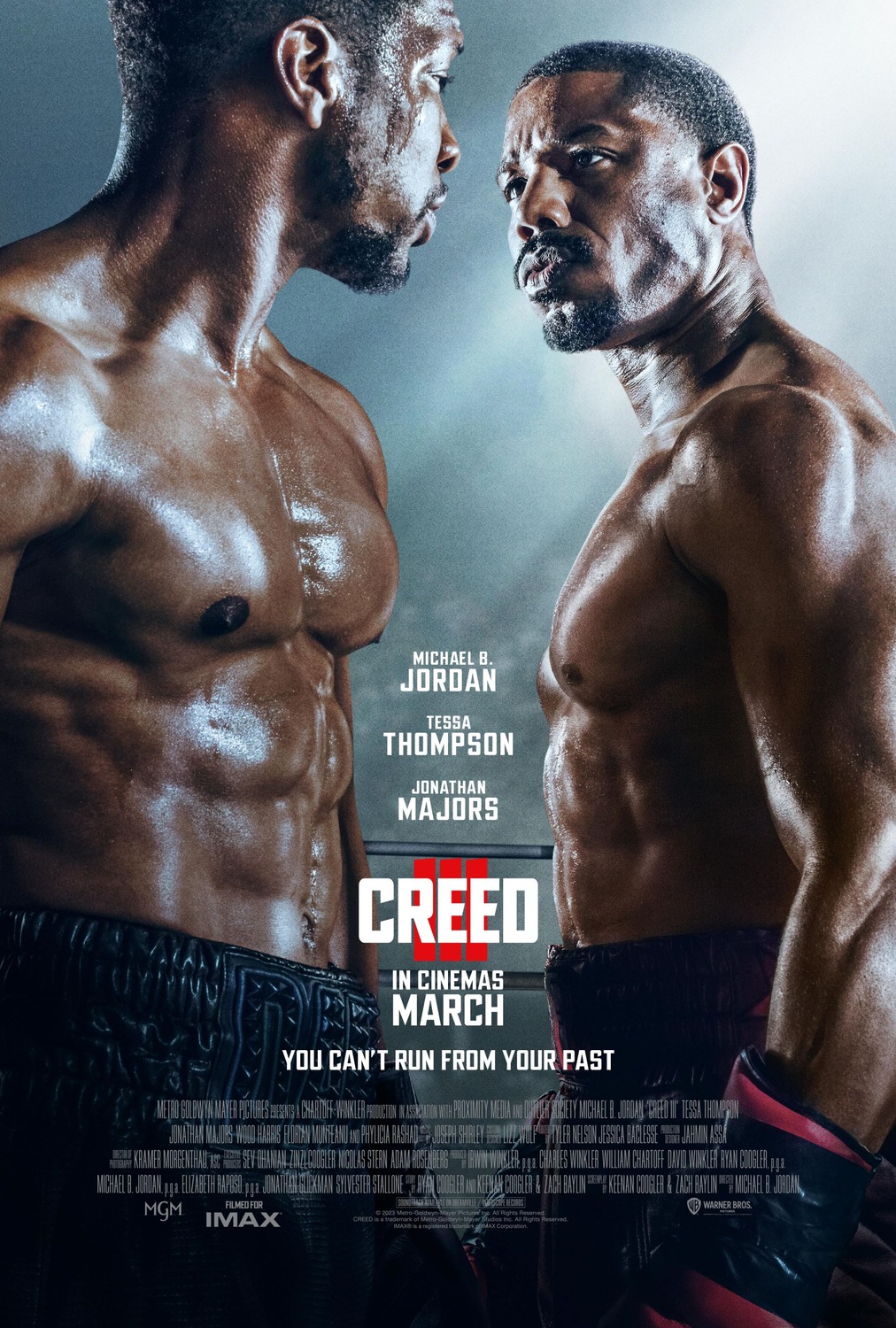 A close-up poster of Michael B Jordan and Jonathan Majors' respective characters in full boxing attire, squaring off against one another.