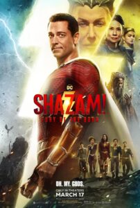 The titular character, Shazam, stands facing to the viewer. Behind him is a lightning bolt and the floating heads of several cast members.