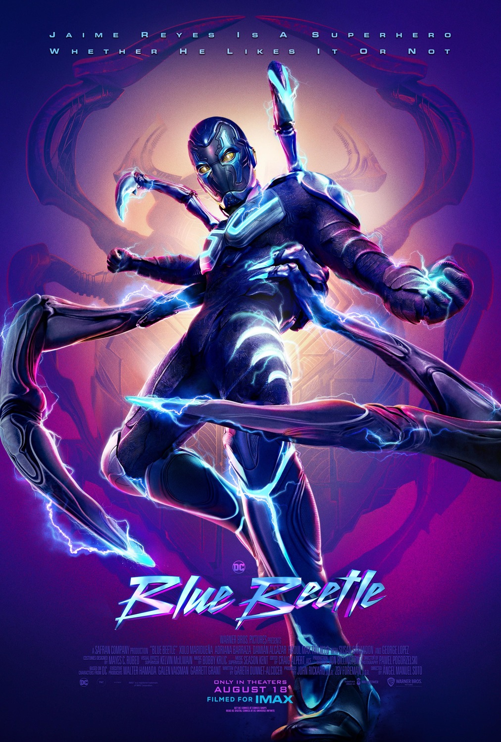 Jamie Reyes as his superhero alter-ego, the Blue Beetle, stands confidently, looking down at the viewer. The alien suit he's wearing has several beetle-like appendages which fill the frame.