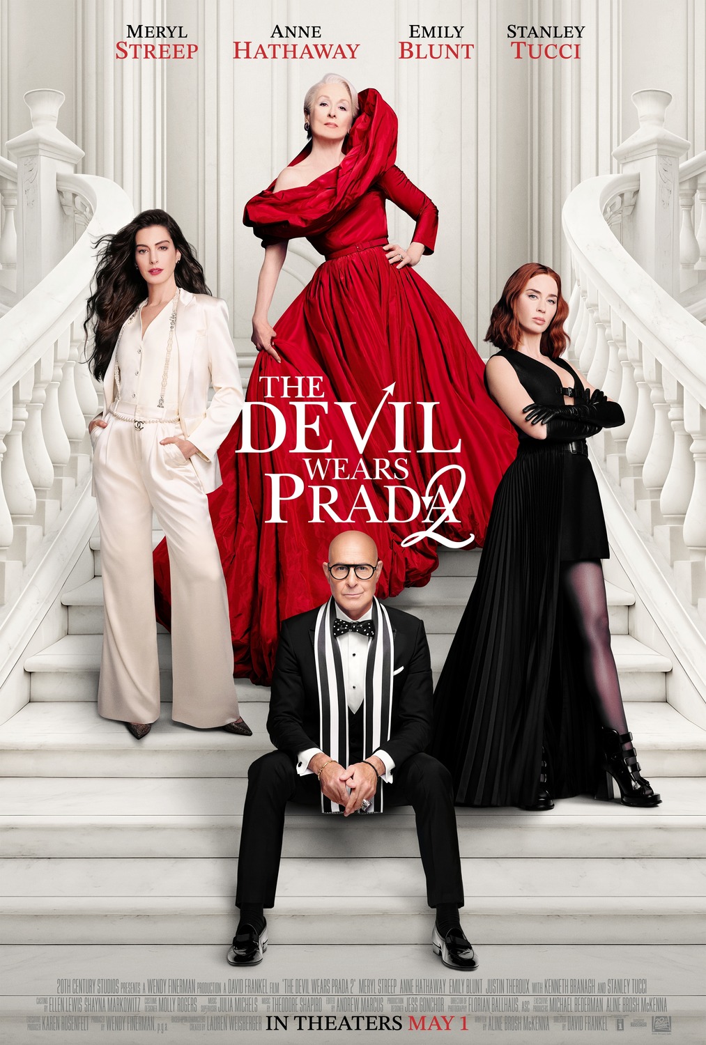 The central characters stand in diamond formation in high fashion clothes on an entirely white staircase